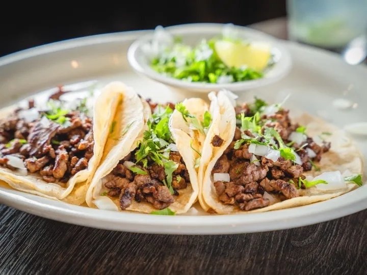 Street tacos on warm corn tortillas with onion and cilantro